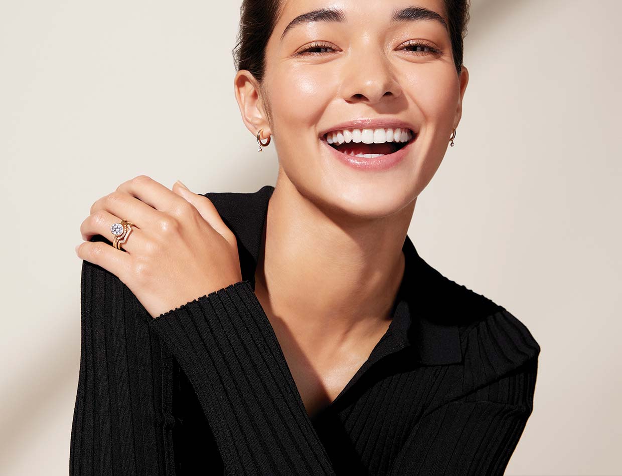 Model laughing wearing unique diamond bridal set